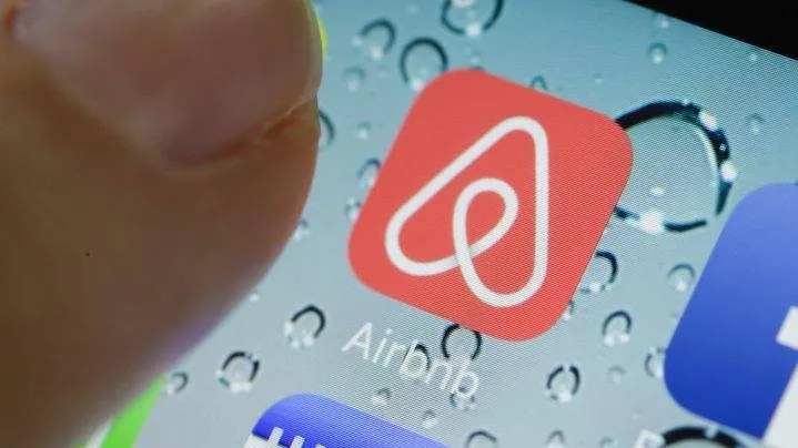 Finger presses on the Airbnb application