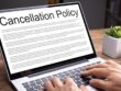 Hands on a laptop with the inscription Cancellation Policies