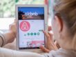 Woman opening Airbnb app on tablet