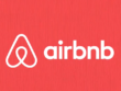 Airbnb logo with white text and symbol on a bright red background