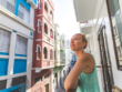 Woman on a balcony among city streets