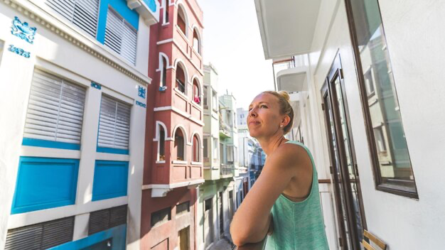 Woman on a balcony among city streets