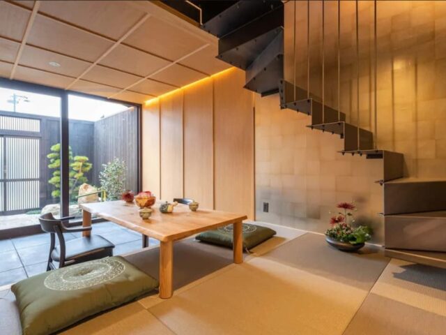 A modern Japanese dining room with tatami mats and stairs.