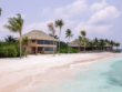 White sandy beach with wooden buildings
