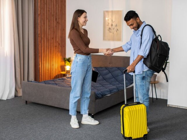 Man Checking to Apartments with a Luggage